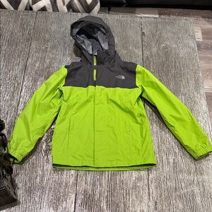 The North Face Kids Lime and Charcoal Raincoat size 7/8 boys small. Some spots